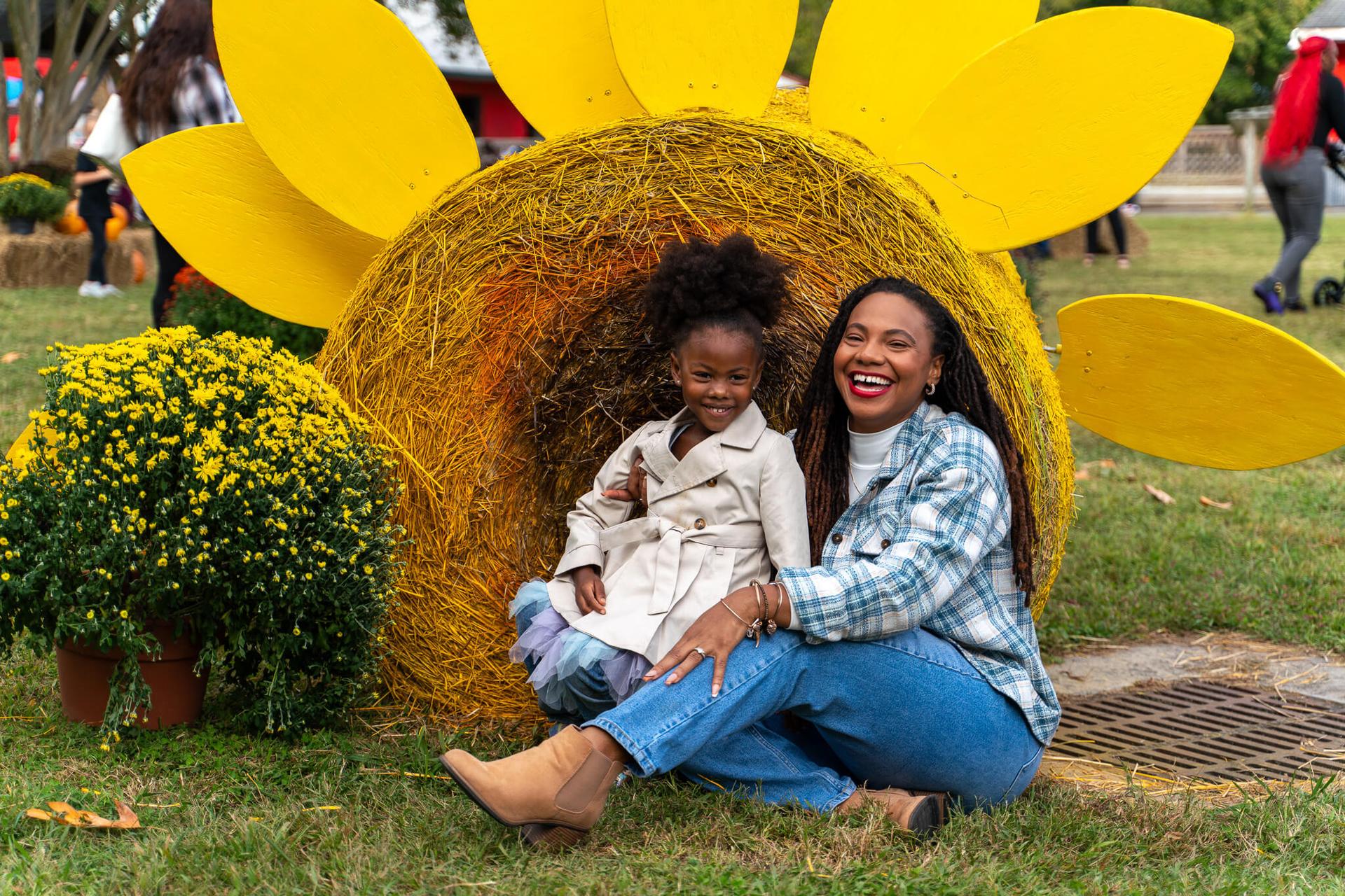 Mother & daughter pose at fall themed photo opps at the Blue Bird Gap Fall Festival in October