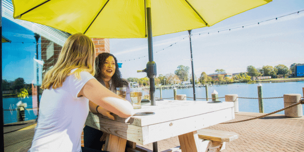 Two girls chat over beer at Bull Island Brewing overlooking the Hampton River