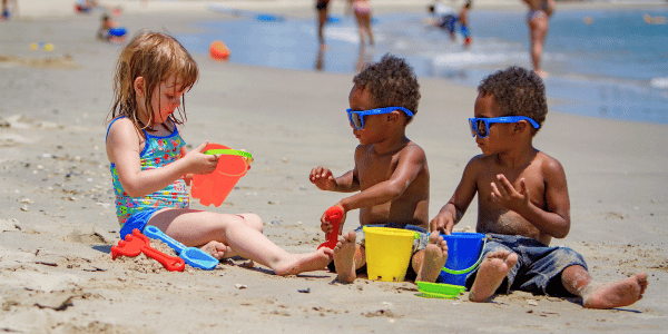 Young children playing with sand toys at Buckroe Beach