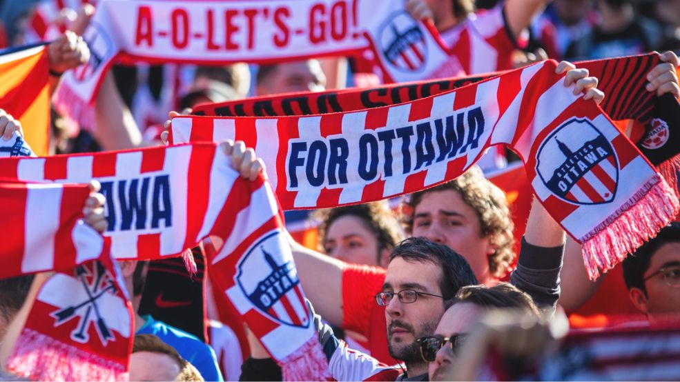 Family stops on bikes to view Parliament Hill and Ottawa River, Special Olympics Ontario School Championships 2025 logo